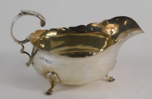 A George V silver sauce boat, with flying S scroll handle, acanthus capped triple hoof feet, Chester 1911, 7cm high, 3.4oz.