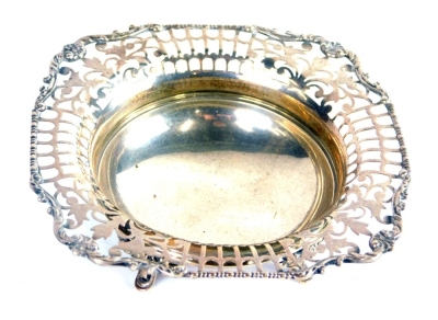 A George V silver dish, with a pierced outline on scroll feet with plain centre, marked Ogdens, Birmingham 1933. 12cm wide, 2.9oz.