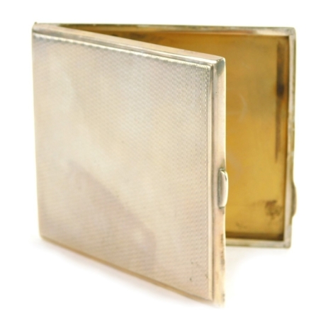 A George VI silver cigarette case, engine turned with vacant cartouche and thumb mould openings, with part fitted interior, Birmingham 1937, 10cm wide, 4oz all in.