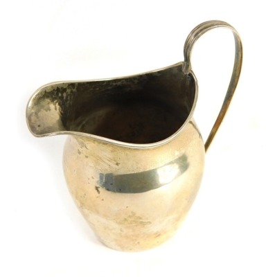 A George III silver jug, by John Hutson, with strap work handle and plain body, London 1799, 12cm high, 2.4oz.