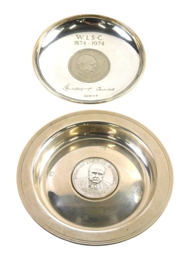 A commemorative Sir Winston Churchill silver dish, of circular form, centred by centenary coin circa 1874-1974, London 1974, 13cm diameter, and a further Sir Winston Churchill commemorative dish centred by a crown, 6.4oz all in. (2)