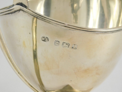 A George V silver two handled sugar bowl, with helmet shaped body, strap work handles, inverted stem and square foot, Birmingham 1910, 12cm high, 3.2oz. - 2