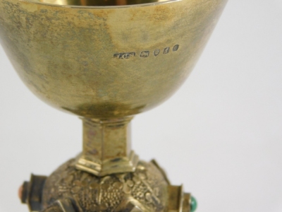 A Victorian silver gilt miniature chalice, with plain bowl elaborate stem inset with jewels, on a jewelled floral base, John Crane Salt, Pratt & Sons London retailers mark, London 1873, 10cm high 3.14oz all in. - 2