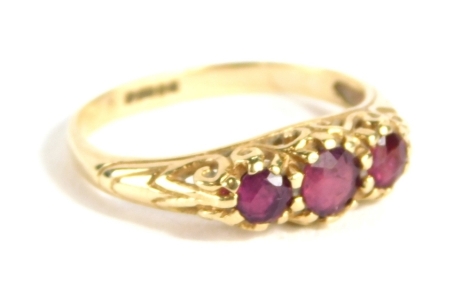 A 9ct gold three stone dress ring, set with almandine garnets, size I, 1.8g all in.