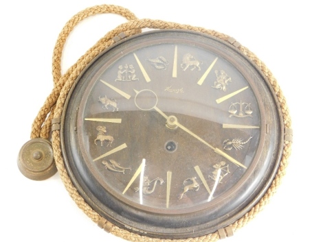 A Kienzle wall clock, in stained beech case, the dial inset with signs of the zodiac, supported by a rope, 24cm diameter.