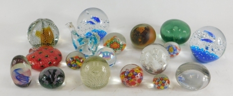 A collection of various coloured glass paperweights, examples decorated with dolphins, a peacock shaped weight, bird, etc., unmarked.