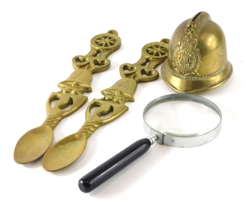 Various brassware, a police helmet money box, 12cm high, spoon wall hangings and a large magnifying glass. (a quantity)