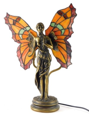 A Tiffany style table lamp, formed as an angel with glass wings with wolves behind, 42cm high.