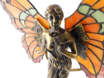 A Tiffany style table lamp, formed as an angel with glass wings with wolves behind, 42cm high. - 2