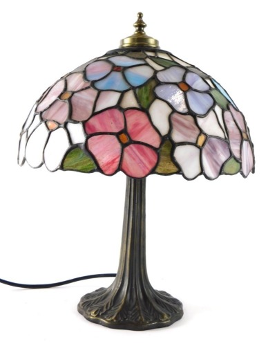 A Tiffany style table lamp, with floral shade in many colours on a turned stem, 56cm high.