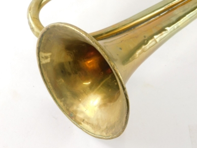 An early 20thC brass bugle, 43cm wide. - 3