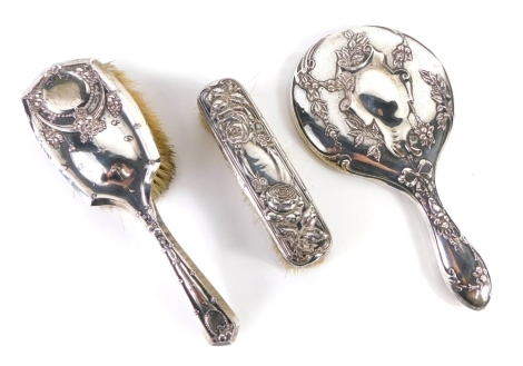 An Edward VII Harlequin part dressing table set, to include clothes brush, similar hand mirror, and associated hairbrush, Birmingham 1909, etc., 30cm high.