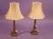 A pair of continental brass column table lamps on square bases and shades