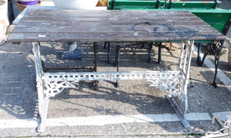 A Victorian Coalbookdale style cast iron table base, with later slatted top, 72cm high, 122cm wide, 64cm deep.