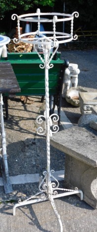 A wrought iron plant stand, with turned scroll stem, on quadruple feet, with circular planter, 110cm high.