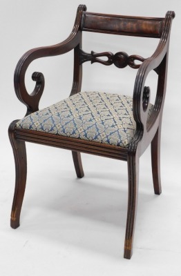 A Regency mahogany open armchair, the bar back carved with flowers, scrolls, etc., with a drop in seat, on sabre legs, and another similar (AF). (2) - 2