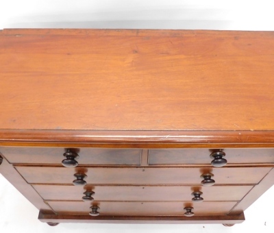 A Victorian flame mahogany chest, of two short and three long cocked beaded drawers, flanked by scrolls, on double bun feet, 127cm high, 124cm wide, 55cm deep. - 2