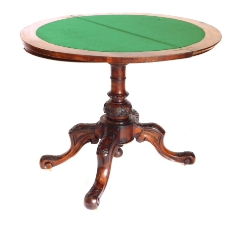 A Victorian figured walnut and a marquetry demi lune shaped card table, the top with a moulded edge, enclosing a baize lined interior, on a carved and turned column and shaped legs with castors, 74cm high, 89cm wide.