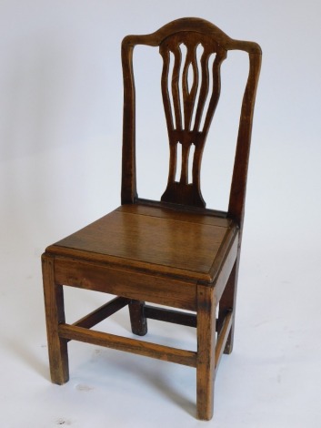 A George III elm side chair, with a vase shaped splat and a solid seat.