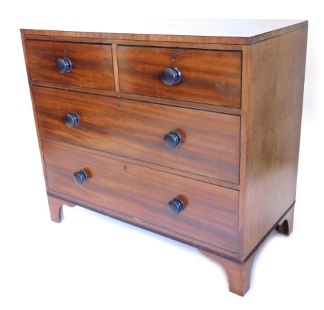 A 19thC mahogany and ebonised chest of drawers, with a plain caddy top above two short and two long drawers, each with turned wood handles on bracket feet, 106cm wide.