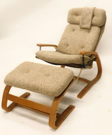 An unusual 1970/80's reclining armchair, upholstered in tweed style fabric, and a matching stool. The upholstery in this lot does not comply with the 1988 (Fire & Fire Furnishing) Regulations, unless sold to a known