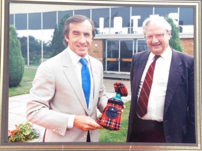 A signed photograph of Jackie Stewart, and a photograph of Jackie Stewart receiving an award from Tony Rudd at Lotus. - 4