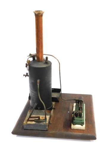 A Stuart steam engine, with boiler, on a wooden base, 40cm high, the base 44cm x 44cm.