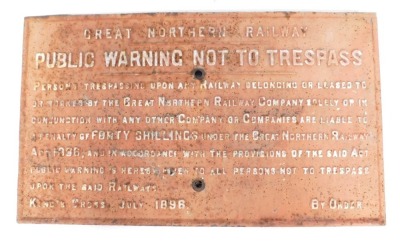 A cast metal railway sign, The Great Northern Railway Public warning not to trespass, on a pink ground, 42cm x 71cm.