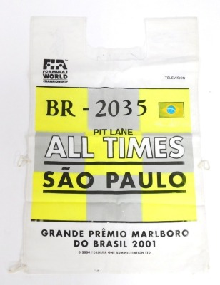 A Formula 1 World Championship Sao Paulo pit lane tabbard for 2001, bearing indistinct signatures, possibly to include Michael Schumacher, Rubens Barrichello, Mika Hakkinen, Nick Heidfeld, Kimi Raikkonen, and others. - 2