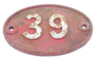 A cast iron railway sign, numbered 39, on a red ground and painted in white, 33cm x 17cm.