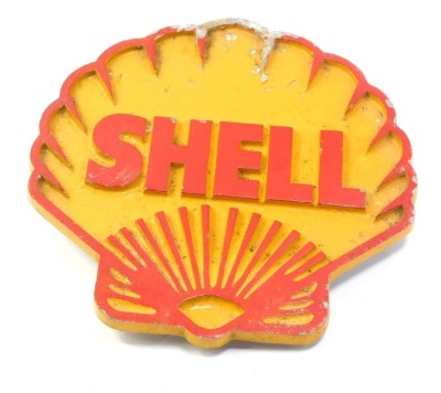 A Shell Motor Oil cast sign, shaped as a shell on a yellow ground with red writing, 26cm x 23cm.