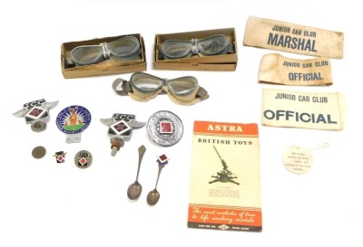 Automobile badges and trinkets, comprising Junior Car Club official armbands, Junior Car Club car badges and pin badges, commemorative spoons, three pairs of driving goggles and an Astra British Toys Microscope information pamphlet. (1 tray)