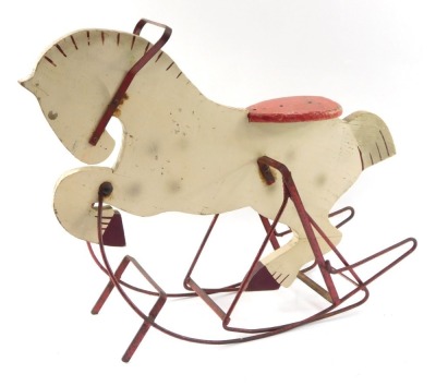 A white painted wooden rocking horse, on a red painted base, 68cm high, 54cm wide.