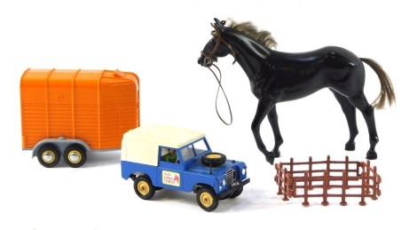 A Britains diecast Land Rover with horse box, and a horse.