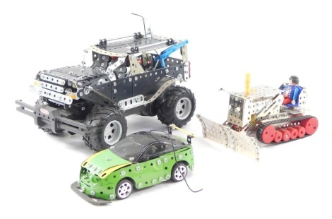 Meccano vehicles, comprising a Meccano Off Road Jeep, a snow plough and a green Meccano battery powered sports car, built. (3)