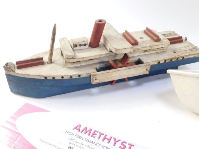 Two painted wooden boats, comprising blue, cream and red painted tug boat, 54cm long, and a white painted speedboat, 61cm long, and an Amethyst Towl Line glider. (3) - 2