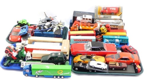 A group of diecast vehicles, play worn, to include trucks, flat bed trolleys, Ringos, Tesco truck, Woolworths. Poundland, Weetabix, 1:43 scale fire and police trucks, diecast models, aeroplanes, monster truck, Porsche 911 Carrera Speedster Race, ANS Ford