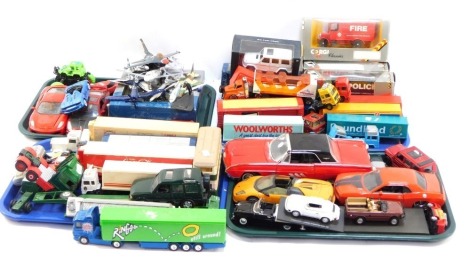 A group of diecast vehicles, play worn, to include trucks, flat bed trolleys, Ringos, Tesco truck, Woolworths. Poundland, Weetabix, 1:43 scale fire and police trucks, diecast models, aeroplanes, monster truck, Porsche 911 Carrera Speedster Race, ANS Ford 