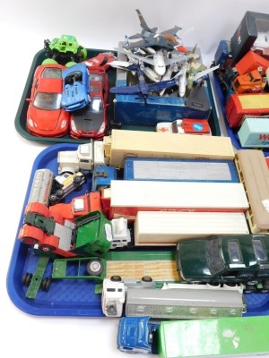 A group of diecast vehicles, play worn, to include trucks, flat bed trolleys, Ringos, Tesco truck, Woolworths. Poundland, Weetabix, 1:43 scale fire and police trucks, diecast models, aeroplanes, monster truck, Porsche 911 Carrera Speedster Race, ANS Ford - 2