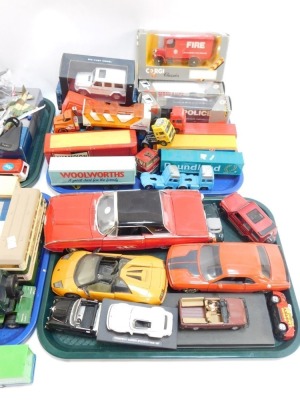 A group of diecast vehicles, play worn, to include trucks, flat bed trolleys, Ringos, Tesco truck, Woolworths. Poundland, Weetabix, 1:43 scale fire and police trucks, diecast models, aeroplanes, monster truck, Porsche 911 Carrera Speedster Race, ANS Ford - 3