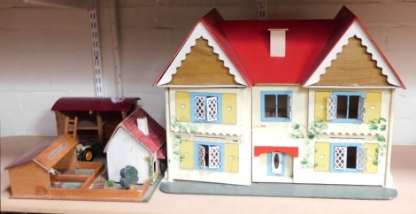 A child's play set, comprising Amanda's Farm play set, a diecast tractor and a doll's house with painted pitch top and swing frame doors, 50cm high, 57cm wide, 33cm deep.