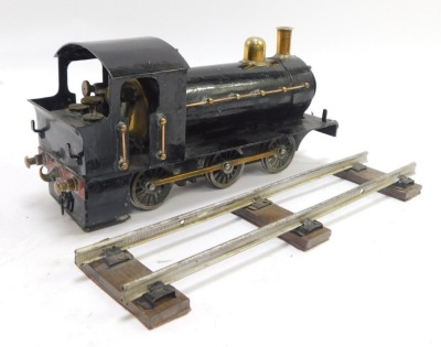 A tin plate locomotive, black livery, with track. - 2