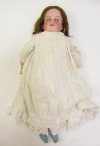 A bisque headed doll, No 370 12-0X-D, with rolling blue eyes, and articulated limbs, in a linen dress with knitted socks, 43cm high. (AF)