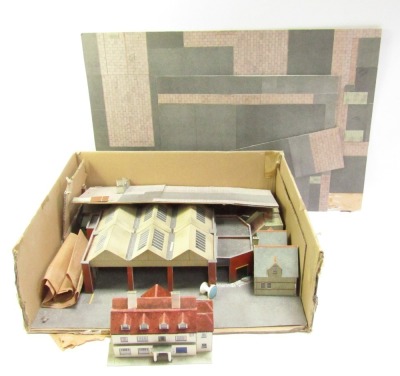 A group of model railways, to include station, station houses, pub, platforms, etc. (a quantity)