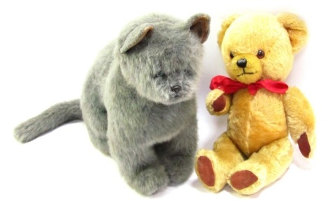 A blonde plush jointed Teddy Bear, with a red bow, 39cm high, and a grey cat, seated to pounce, 34cm high. (2)