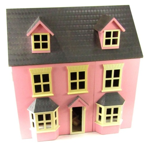 A wooden two storey Victorian style doll's house, in pink with bay windows and cream surrounds, 62cm high, 62cm wide and 41cm deep.