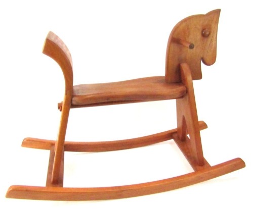 A wooden child's rocking horse, 64cm high, 86cm wide, 33cm deep.