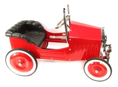 A Kalee child's red pedal car, with leather seat and chrome supports, 54cm high, 80cm wide.