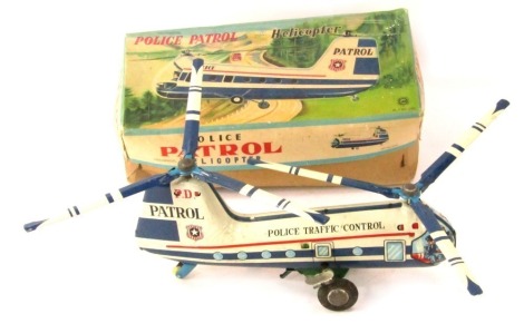 A tin plate mechanical police patrol helicopter, boxed.