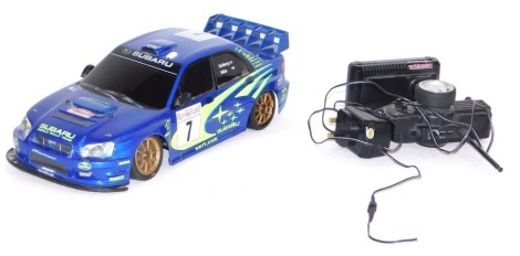 A Carisma Subaru remote controlled car, with charger and controller.